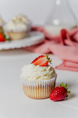 Muffins Cupcake cream decorated with colorful sprinkles on white background and strawberries 