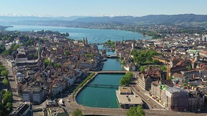 Stunning aerial footage of Zurich old town and downtown along the Limmat river and lake Zurich in Switzerland largest city