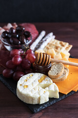 Charcuterie meat cheese board on slate board