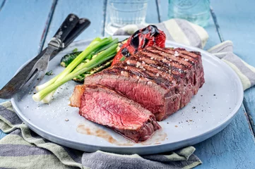 Gartenposter Modern style traditional barbecue dry aged angus sirloin beef steak served with vegetable as close-up on a Nordic design plate © HLPhoto