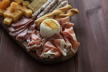 Charcuterie meat cheese board on slate board