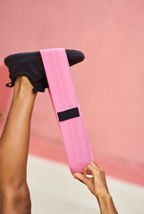 A sports girl with resistance bands does an exercise. .