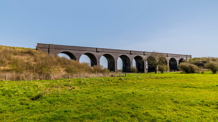 Fototapeta na wymiar An oblique view towards the abandoned Helmdon viaduct on a bright Spring day