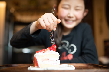 バースデーケーキを食べようとする子供