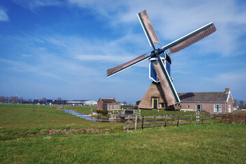 Fototapeta na wymiar Windmill under the clear sunny sky