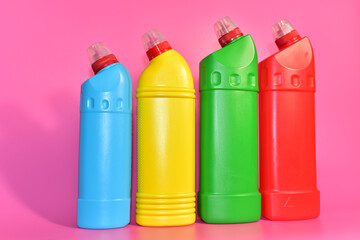 Detergent bottles on pink background. Detergents and laundry for cleaning. Household chemicals concept. Chemical liquid for washing. Concentrated and anti-bacterial liquids for dishwasher