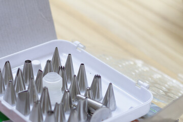 A set of steel tips of different shapes for a pastry bag for squeezing cream or dough