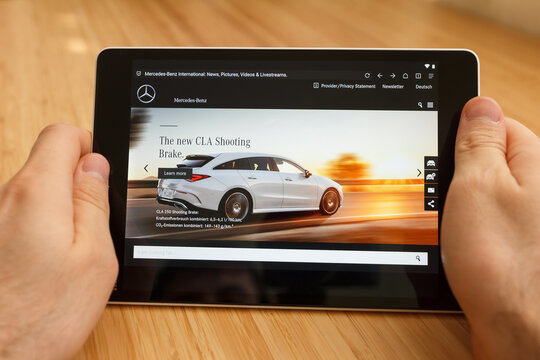 SAN FRANCISCO, US - 1 April 2019: Close up to hands holding tablet using internet and looking through Mercedes-Benz web site, in San Francisco, California, USA. An illustrative editorial image.