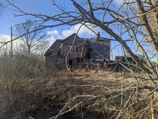 old and broken wooden house in the early spring during the day