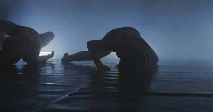Silhouette of group dancers of contemporary ballet, ow key