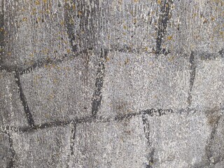 old and gray concrete wall with black painted lines from paint