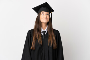 Teenager Brazilian university graduate over isolated white background and looking up
