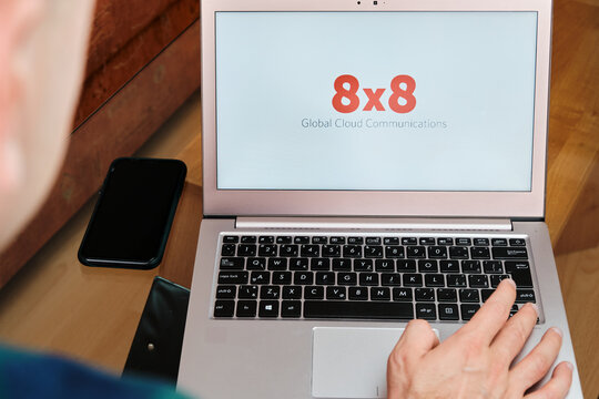 8x8 is used for business meeting on laptop by man. An illustrative editorial image. San Francisco, US, June 2020.
