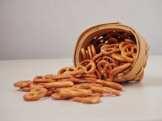 Hard Pretzels or Salted pretzels snack for party in white bowl on wooden floor.