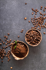 black arabica coffee beans freshly ground aromatic in coconut bowl, top view with place for text