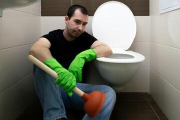 Drain Problems, blockage plumbing toilet unclog plunger force cup man sit floor