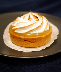 French dessert with swirled fresh cream, lemon meringue tart