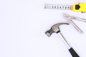 Top view of Set of construction and maintenance tooling for handyman on white concrete background with copy space
