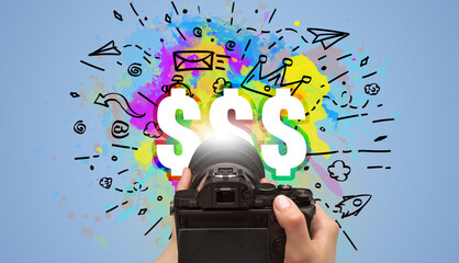 Close-up of a hand holding digital camera with abstract drawing concept