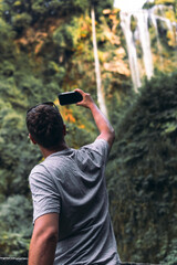 Tourist man look at waterfall in Italy (Cascata delle Marmore) in Umbria. small, calm water...