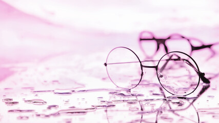 Tools for vision correction. Glasses and lenses with diopters on the background of splashes and...