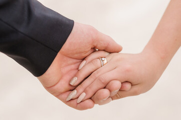 The groom holds the bride's hand