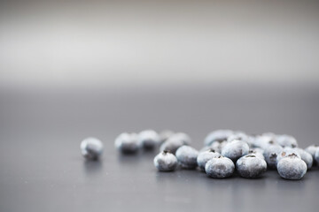 Water drops on ripe sweet blueberry. Fresh blueberries background with copy space for your text. Vegan and vegetarian concept. Macro texture of blueberry berries.