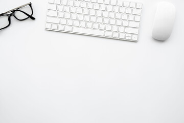 Minimal white office desk table with computer keyboard and mouse. Top view with copy space, flat lay.