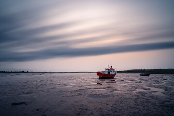Fishing low tide at sunset long exposure
