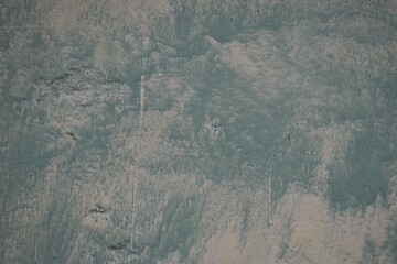 Concrete texture. Abstract cement background wallpaper. Washed watercolor white paint over dirty cyan paint on old concrete surface. Abstract grunge background.