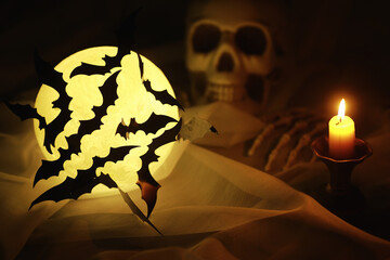 Black silhouettes of bats on a background of the moon. Halloween concept. Scary background....