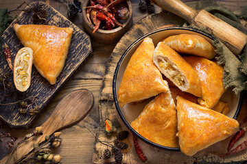 pies with cabbage and shortbread egg on wooden boards in a rustic style