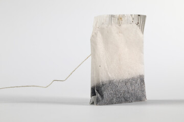 Tea bag with twine on white