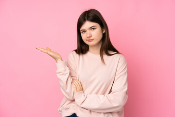 Young Ukrainian teenager girl over isolated pink background unhappy for not understand something