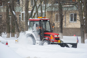 Tractor for snow removal is parked on a city street
