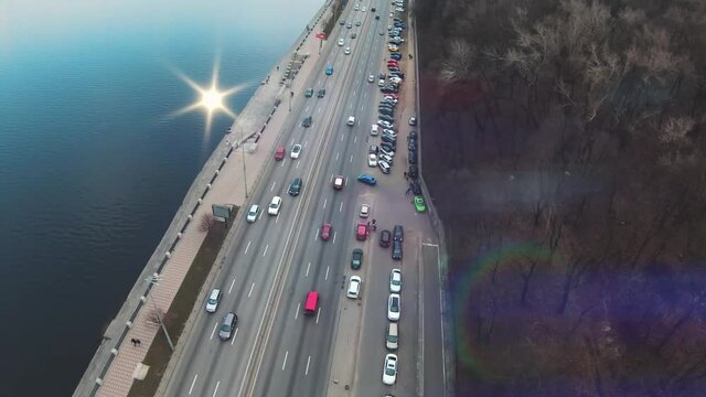 Aeria view road with driving cars near river. Drone, cars trucks, forest, tourist, water, urban, infrastructure, city, architecture, aerial, copter, travel. Slow motion