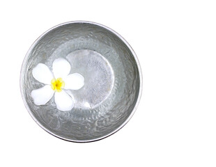pure white frangipani (plumeria) flower floating on water surface in silver metal bowl isolated on white background, tropical flower and aluminum utensil for thai culture songkran festival, top view