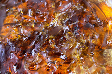 Brown rosin for soldering in a jar, background