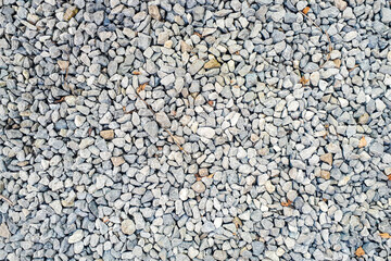 Closeup gravel texture pattern. Grey natural road background. Top view of small rocks