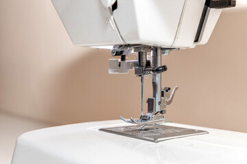 Sewing hobby background. Close up process of sewing on a sewing machine with copy space.