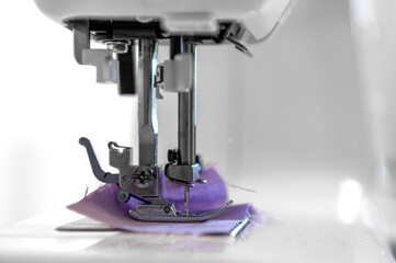 Sewing hobby background. Close up process of sewing on a sewing machine with copy space.