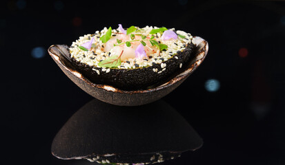 avocado slice with sesame seeds, scallop, herbs and violet
