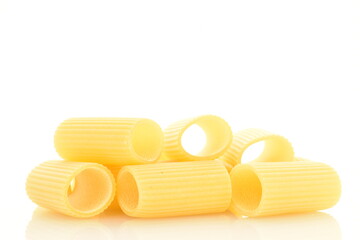 Bright yellow uncooked pasta, close-up, isolated on white.