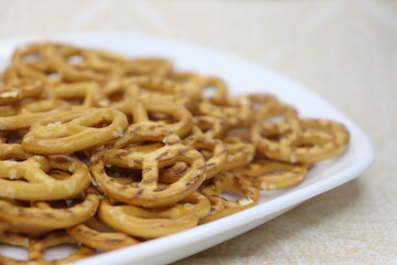 Pretzel. A small bakery with a diameter of about 10-15 cm in the shape of a pretzel, popular in...