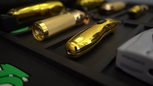 barber hair clippers and equipment set in the barbershop slow motion 120 fps video cinematic barber clippers gold cordless hair clippers.