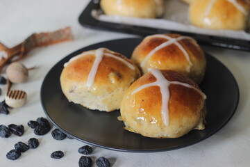 Freshly baked hot cross buns. A sweet fruit bun lightly spiced with cinnamon and nutmeg and marked with a cross on top is served on Good Friday.