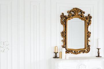 Old vintage mirror with gold colored wooden ornament frame, copy space.