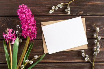 Greeting card mockup with hyacinth flowers and willow twigs on wooden background