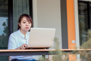 Asian woman working laptop. A woman working on a laptop at home