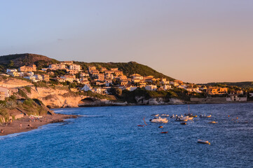 Panoramic view of the village in the rocks and boats at sea of the island of Sardinia